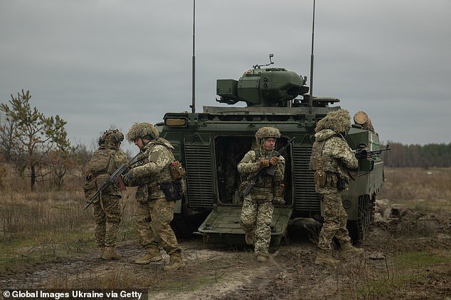 Ukrainian soldiers leave a Marder Infantry Fighting Vehicle (IFV) in Donetsk Oblast, Ukraine, on December 7