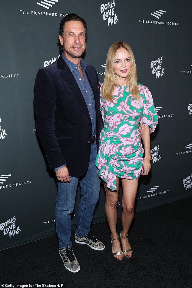 Graham wore a teal and pink patterned mini dress and strappy heels as she attended the Skatepark Project Gala in Los Angeles with boyfriend John de Neufville last month