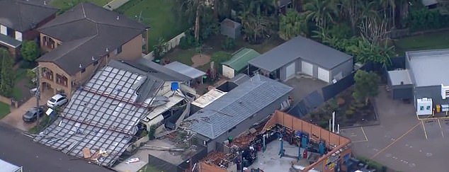 A roof was blown off a warehouse (pictured) in Long Jetty on the NSW Central Coast on Saturday after damaging winds lashed this town in the afternoon