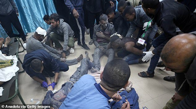 Wounded Palestinians are treated on the floor of Al-Aqsa Martyrs Hospital in Deir al-Balah, Gaza