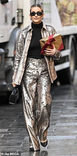 Ashley, 42, took it one step further as she stunned in matching silver sequin trousers and a two-piece jacket.