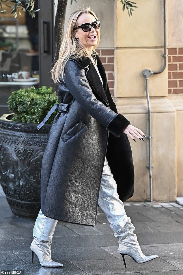 Basking in the cold, she completed the look with a long leather coat with sheepskin collar and cuffs and her signature sunglasses