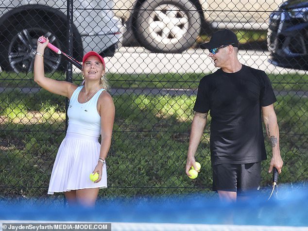 The pair practiced their tennis skills by hitting balls across the court