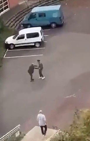 A video shows a confrontation between two men on school grounds