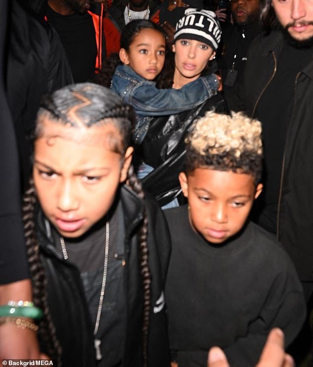 Her friends believe she's finally showing elements of her 'true self' – pictured with Kanye's children (L-R) North, ten, Chicago, five, and Saint, eight at the listening party
