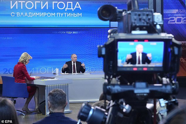 Russian President Vladimir Putin (C) answers questions during his annual press conference with Russian federal, regional and foreign media at the Gostiny Dvor Forum Hall in Moscow, Russia, December 14, 2023