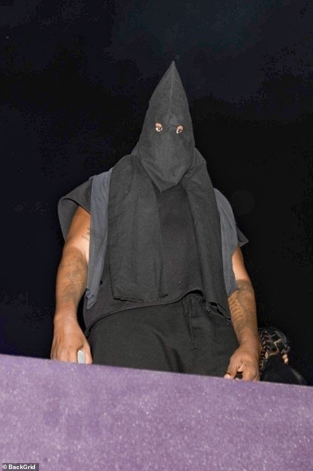 Yelling at the crowd to 'shut up', he said: 'I don't care about life or death, I get visited by my children' before adding: 'F*** Balenciaga' (seen wearing a hood of the Ku Klux Klan type in Miami on Tuesday)