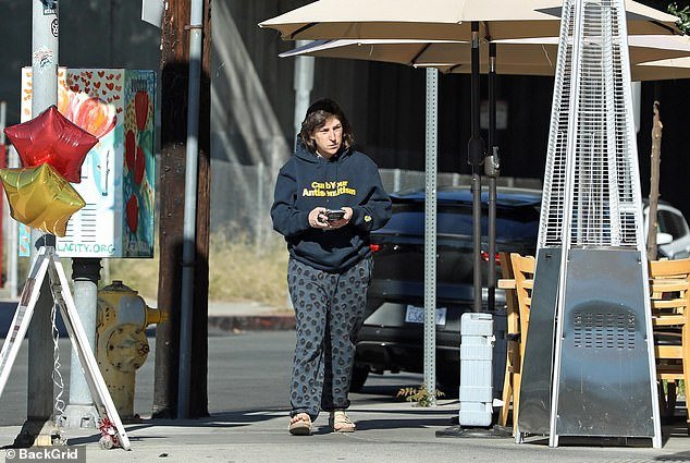 For her outing, she wore blue pajama pants with a cheetah print and a navy blue hoodie that read: 