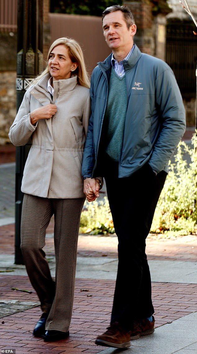 King Felipe VI's sister, Infanta Cristina of Spain, 58, left, pictured with her 25-year-old husband Iñaki Urdangarin, 55, before their divorce in 2022 (pictured together in 2019 in Vitoria).  The couple have four children, but their marriage collapsed after he was sentenced to five years in prison for financial crimes in 2018 and faced cheating charges.