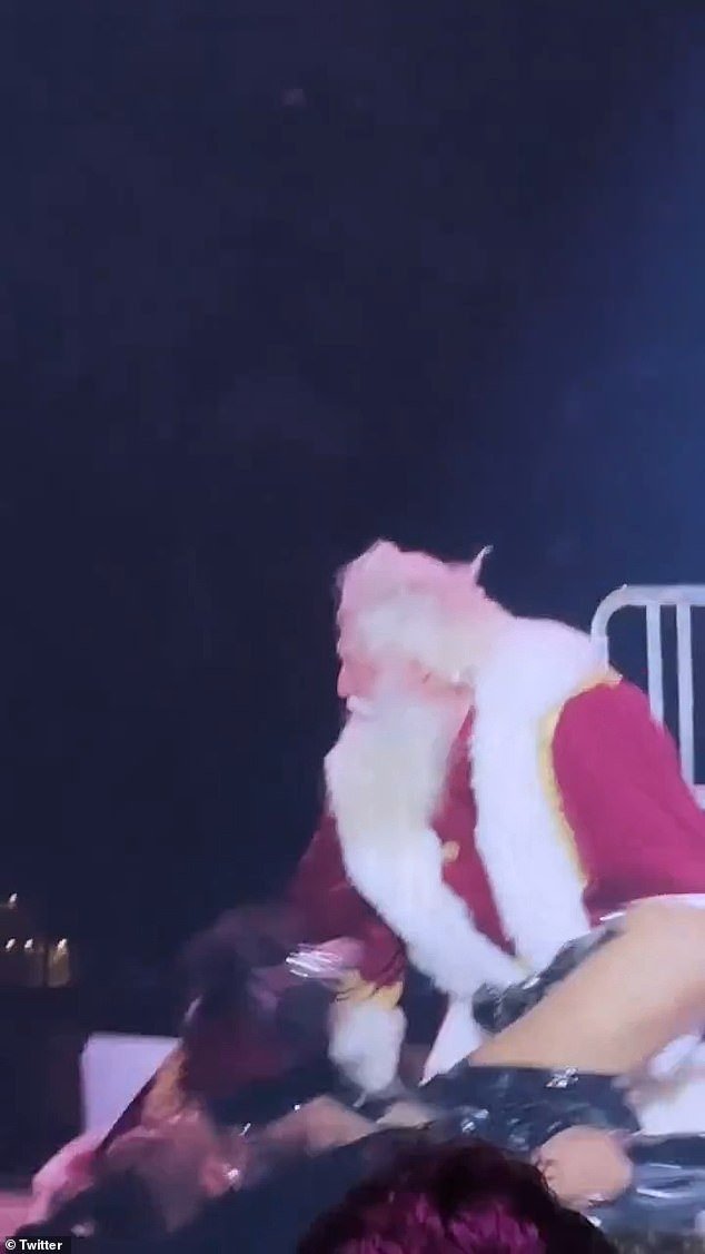 Both the dancer and the other backup dancers continued to dance after the fall while Santa gathered