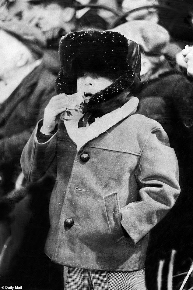 Seven-year-old David Powell - cousin of Fulham's Dave Mitchell - in the snow at Craven Cottage with a mince pie in 1962