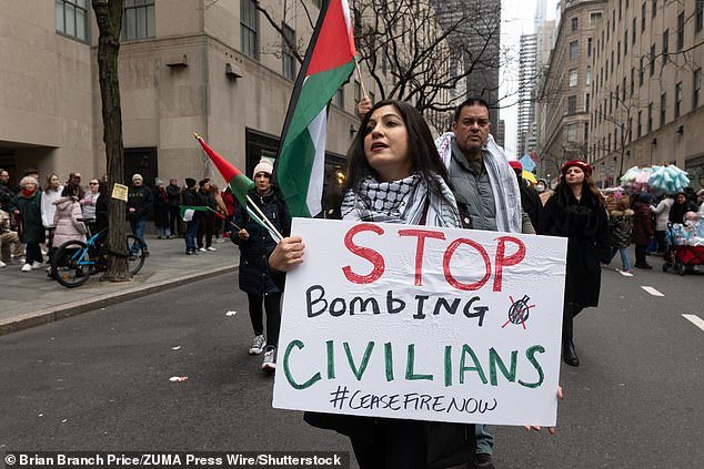 A female protester demonstrates in New York City holding a sign calling on Israel to 'stop bombing civilians'