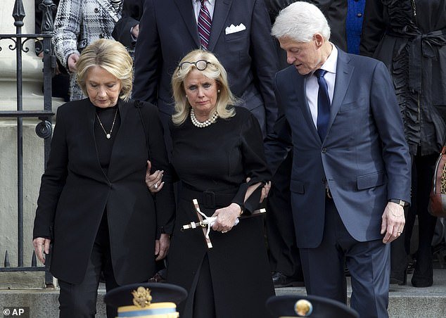 Rep. Debbie Dingell, D-Mich., center, joined by former President Bill Clinton and former first lady Hillary Clinton follows the flag-draped casket of former Rep. John Dingell after a funeral service at Holy Trinity Catholic Church, Thursday, Feb. 2.  14, 2019, in Washington.  Dingell, the longest-serving congressman in American history who mastered legislative deal-making and fiercely protected Detroit's auto industry, has died at the age of 92.