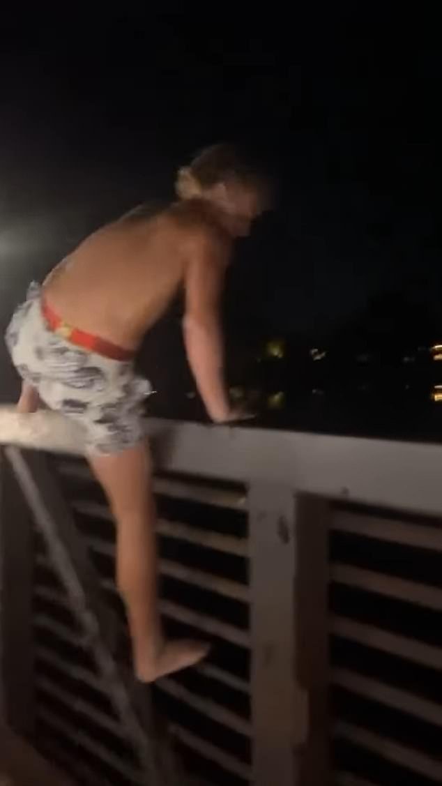 Children cheered the boy covered in gasoline as he climbed the railing before doing a backflip