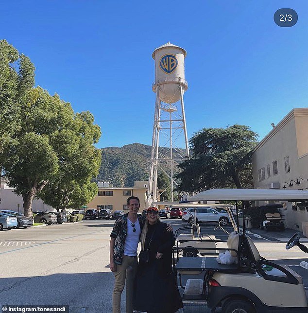 The Dance Monkey hitmaker shared a photo of herself in a studio lot, with the iconic Warner Brothers water tower behind her, and revealed she had written music for the superhero sequel