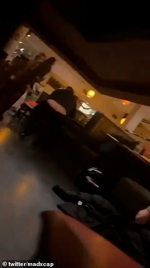 The videos also appear to show people taking cover inside the restaurant