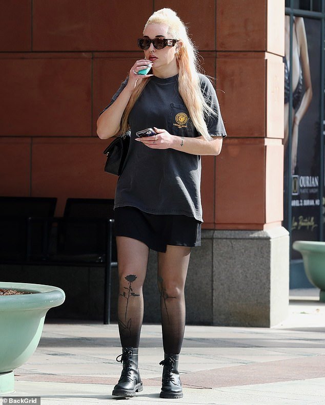 The actress, who recently went back and forth with the color of her hair, opted for a black T-shirt worn over a matching skirt as she stepped out