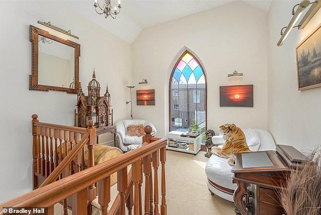 The renovated property retains many original features including this arched window with some decorative glass