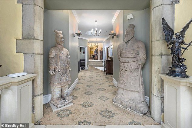 The house has a long hallway on the ground floor with statues at the entrance keeping watch
