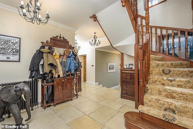 The property is arranged over three floors, with carpeted floors leading up the stairs from the entrance hall