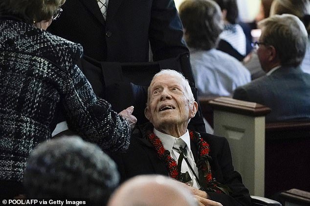 President Jimmy Carter, 99, appears at his wife Rosalyn Carter's funeral in Atlanta last month.  President Joe Biden and first lady Jill Biden attended the memorial service, along with President Bill Clinton and several former first ladies