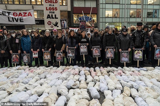 Effigies of children murdered in Gaza were seen after people took part in a silent procession through Midtown Manhattan earlier Thursday