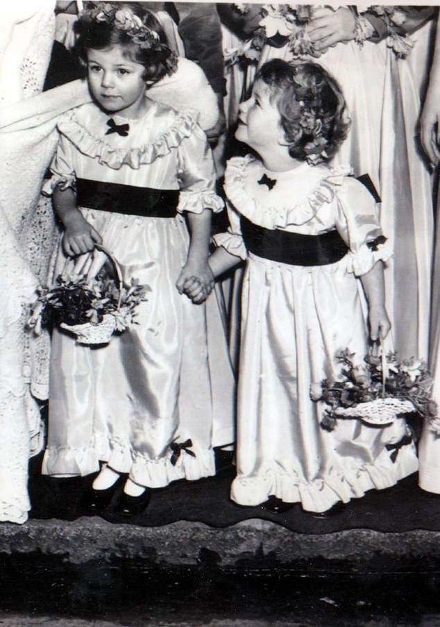 Camilla (L), four years old, and Annabel, two years old, are pictured dressed as bridesmaids in 1952