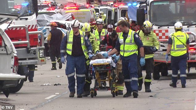 Fire and Rescue NSW service commander Phil Vaiciurgis described the crash as 'a confronting scene of carnage' (pictured, paramedics with one of the injured)