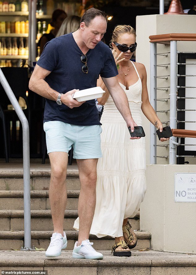 Lachlan, meanwhile, was dressed in a navy blue T-shirt, light blue shorts and white sneakers