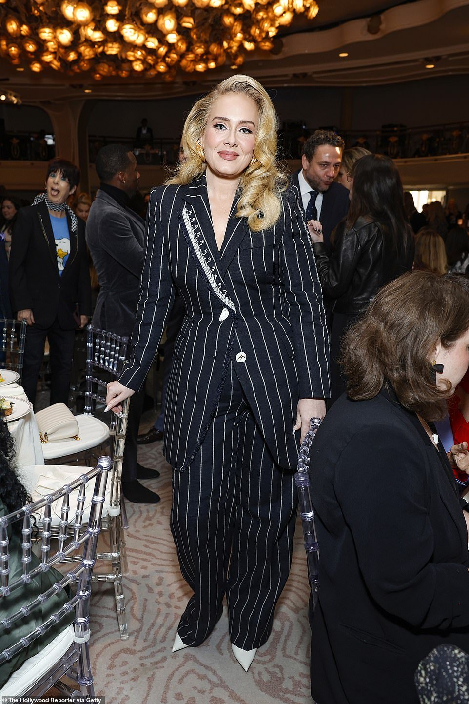 Adele wowed in a fitted black and white pinstripe suit at The Hollywood Reporter's Women in Entertainment Gala at the Beverly Hills Hotel in Los Angeles