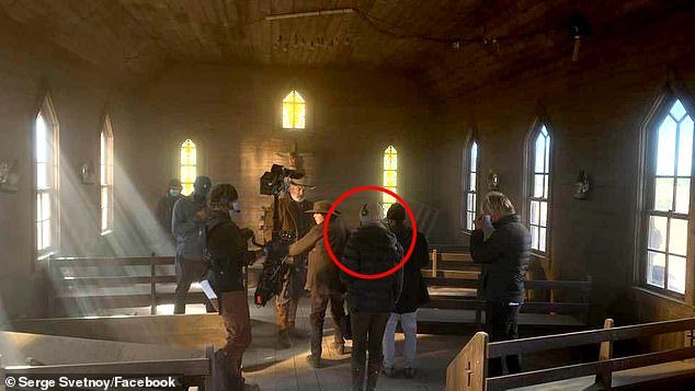 A final photo of Hutchins filming with Baldwin in the chapel where she was shot