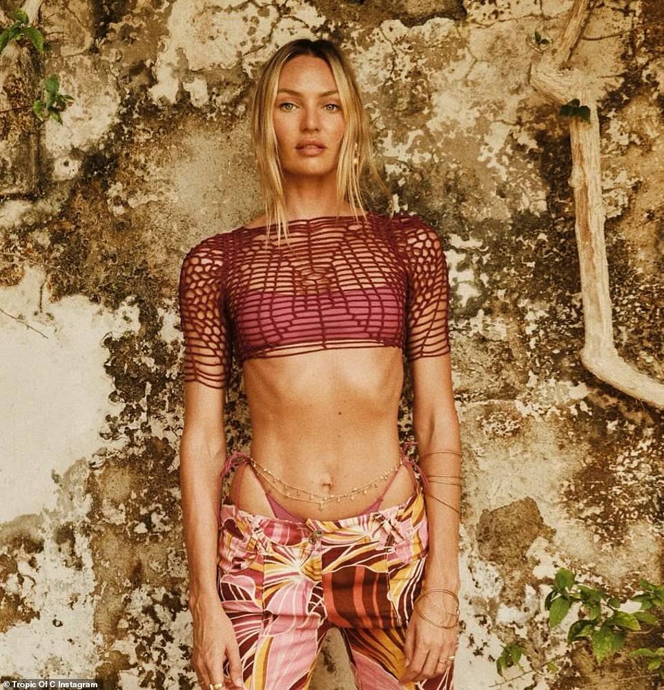 Candice Swanepoel shows off her VERY toned tummy in a