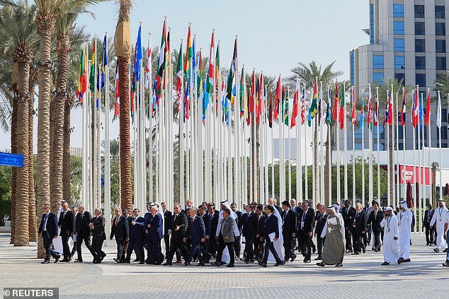 This includes 97,000 registered official delegates with access to the secure inner 'Blue Zone'.  Pictured: World leaders and delegates walk in Dubai's Expo City, December 1