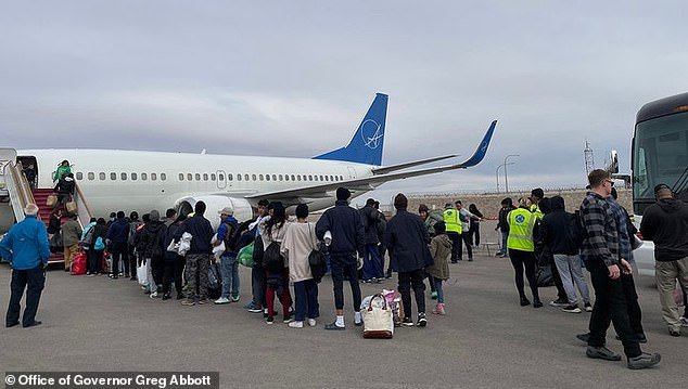 Migrants line up in El Paso on December 19 to board a plane to Chicago