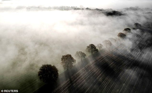 Pictured: Plowed fields shrouded in mist in Keele, Staffordshire