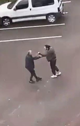 A video shows a confrontation between two men on school grounds