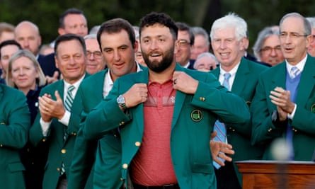 Jon Rahm receives a green jacket from Scottie Scheffler after winning the 2023 Masters