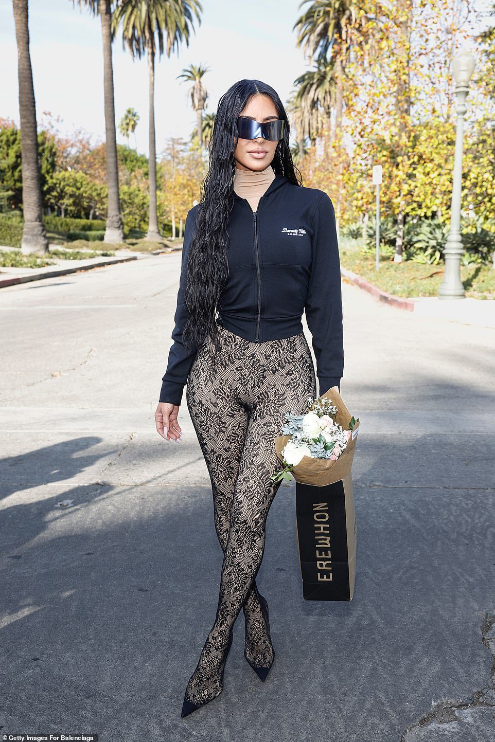 The reality TV star, 42, sizzled in a pair of skintight nude lace leggings that showed off her famous hourglass curves, and featured built-in heels