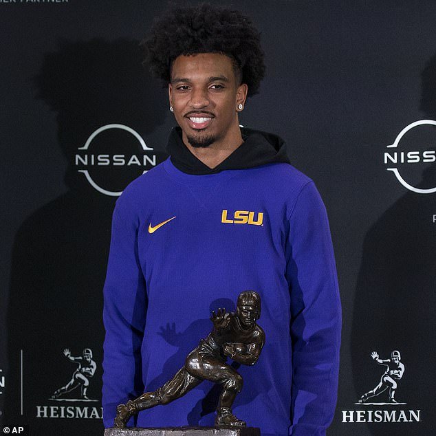 Heisman Trophy finalist LSU quarterback Jayden Daniels poses with the famous statue