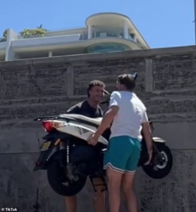 A TikTok shows the two men picking up the scooter and carrying it away to make room for their car at Bondi Beach in Sydney on Thursday