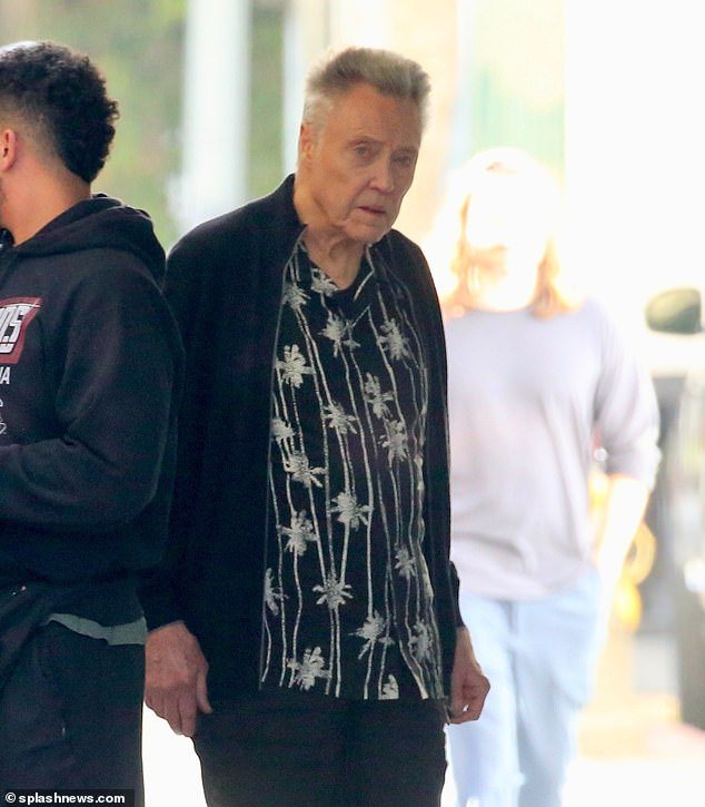 Walken was spotted wearing a black button-down shirt with white palm trees over a black zip-up sweater.