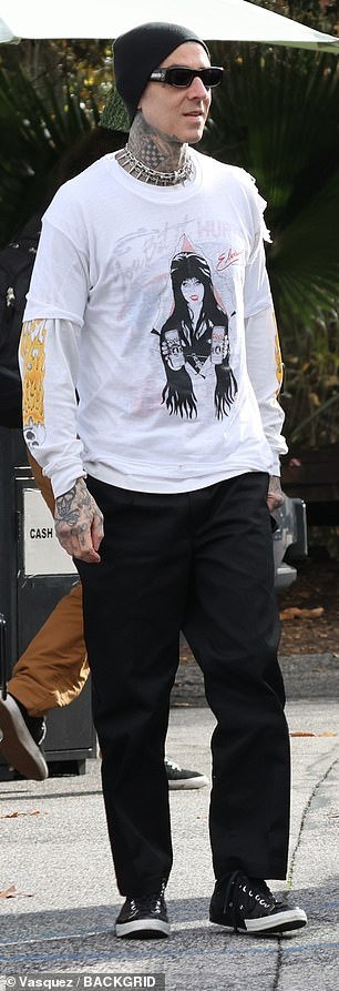He wore the 'Mistress of the Dark' t-shirt over a white long sleeve t-shirt and wore a thick silver chain around his neck