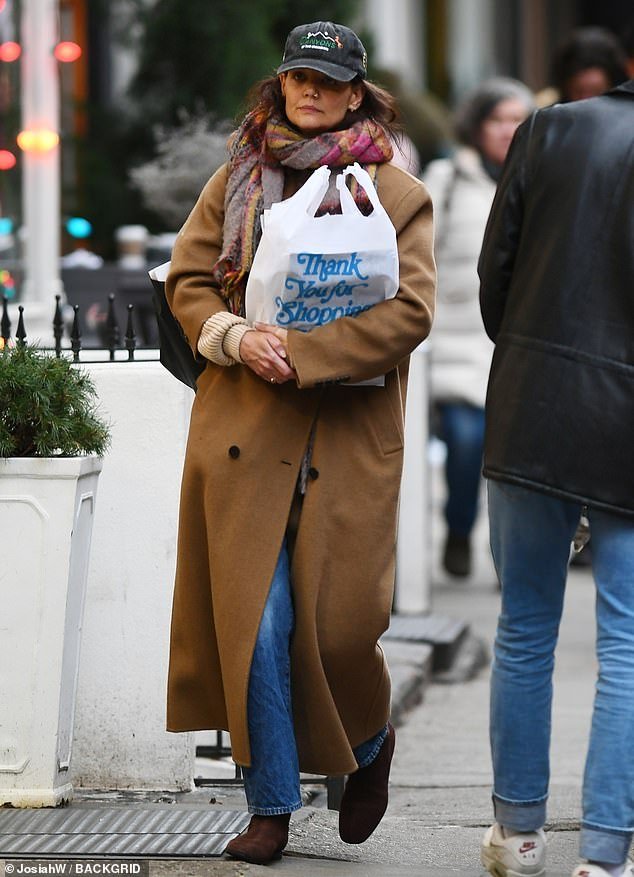 The actress, who is known for her sophisticated street style, did her shopping in an ankle-length, double-breasted camel coat.  As the director walked down the sidewalk, she revealed that she was wearing straight-leg jeans and brown boots