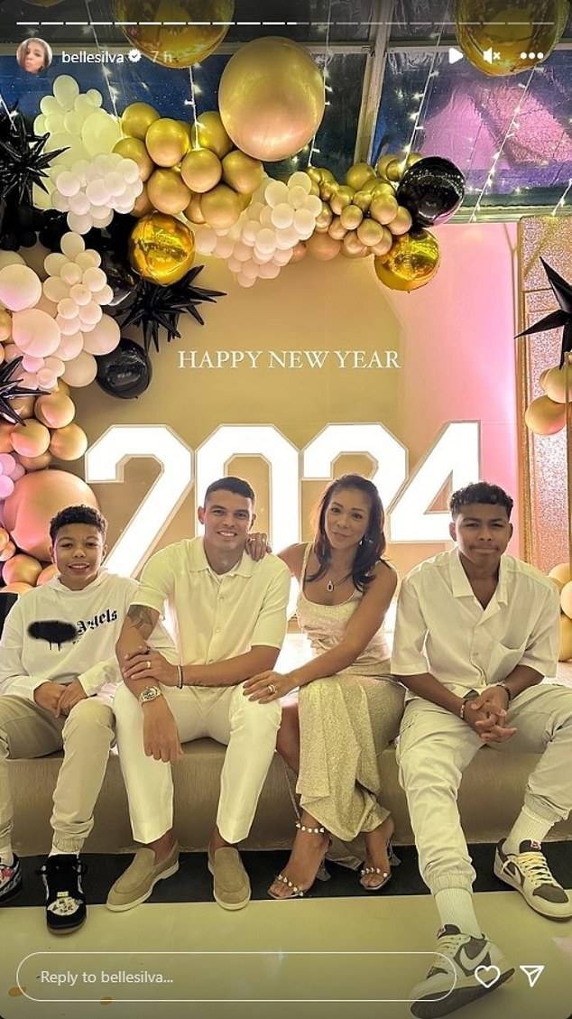 Thiago Silva and his wife Belle Silva pose with their two sons at a New Year's Eve party