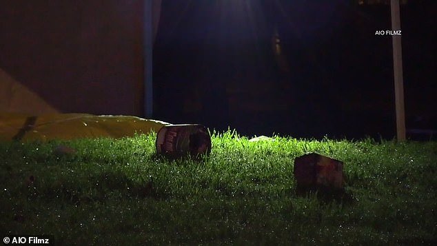 After the fatal incident, used fireworks containers lie on the grass