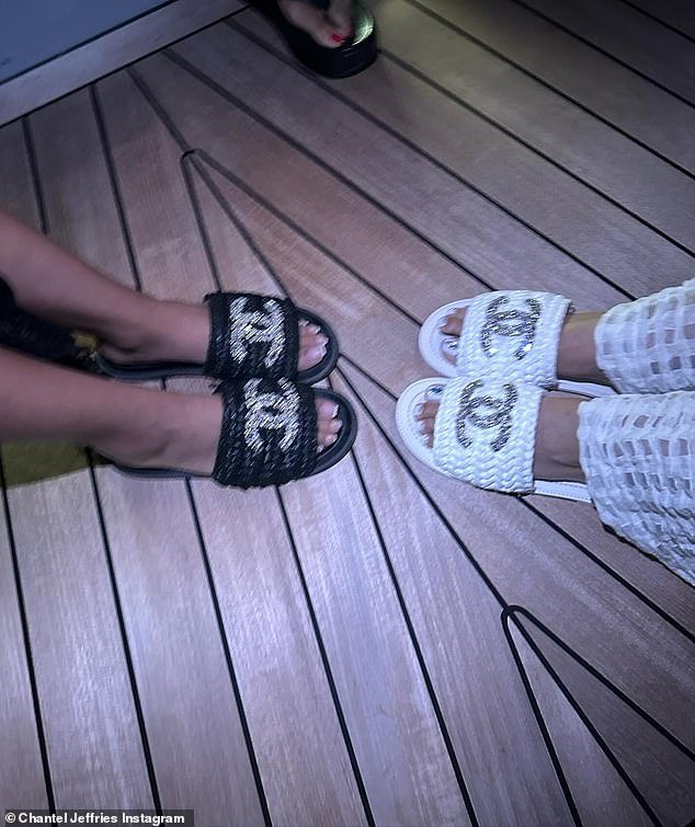 Another photo showed the matching Chanel slippers she and her friend were wearing.  The logo was blinged with a woman in black slippers and one in white