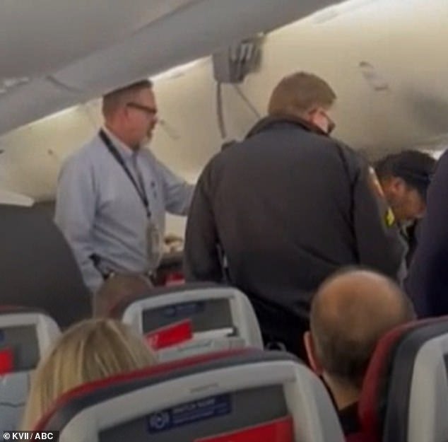 The passenger had punched the flight attendant in the face and kicked one of the police officers in the groin