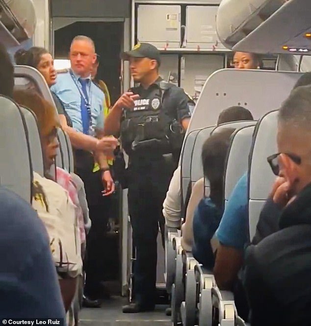 Police speak to the pilot and cabin crew after they board the plane