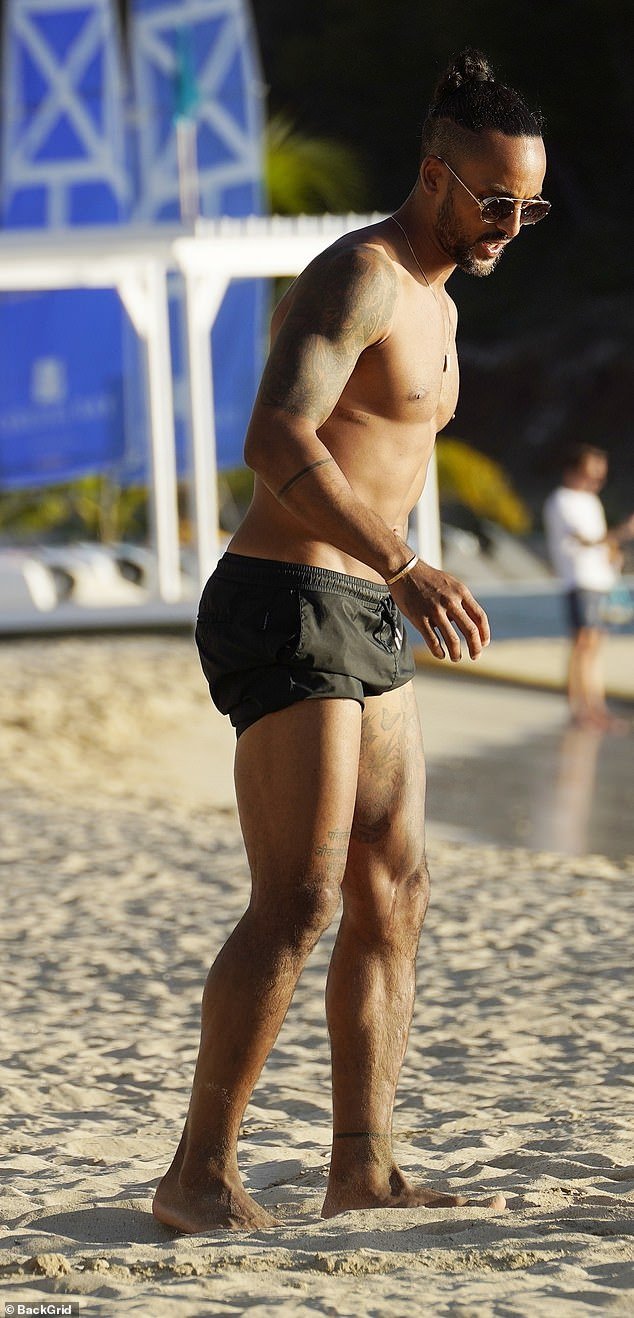 Theo showed off his muscular body and intricate tattoos as he went shirtless in black board shorts
