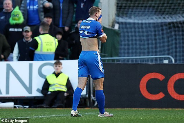 Eastleigh's George Langston looks dejected as he leaves the field after being shown a red card